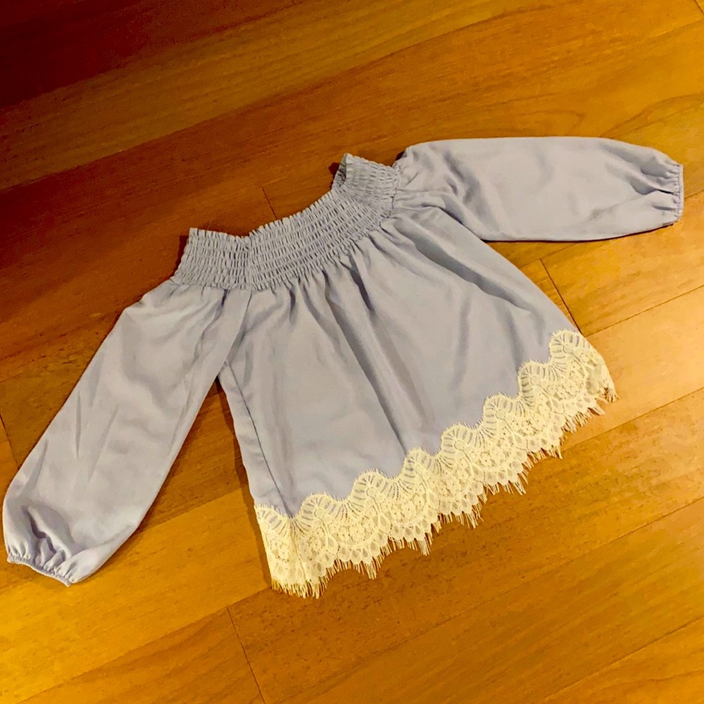 Off shoulder powder blue long sleeve blouse with white lace at the bottom. Small